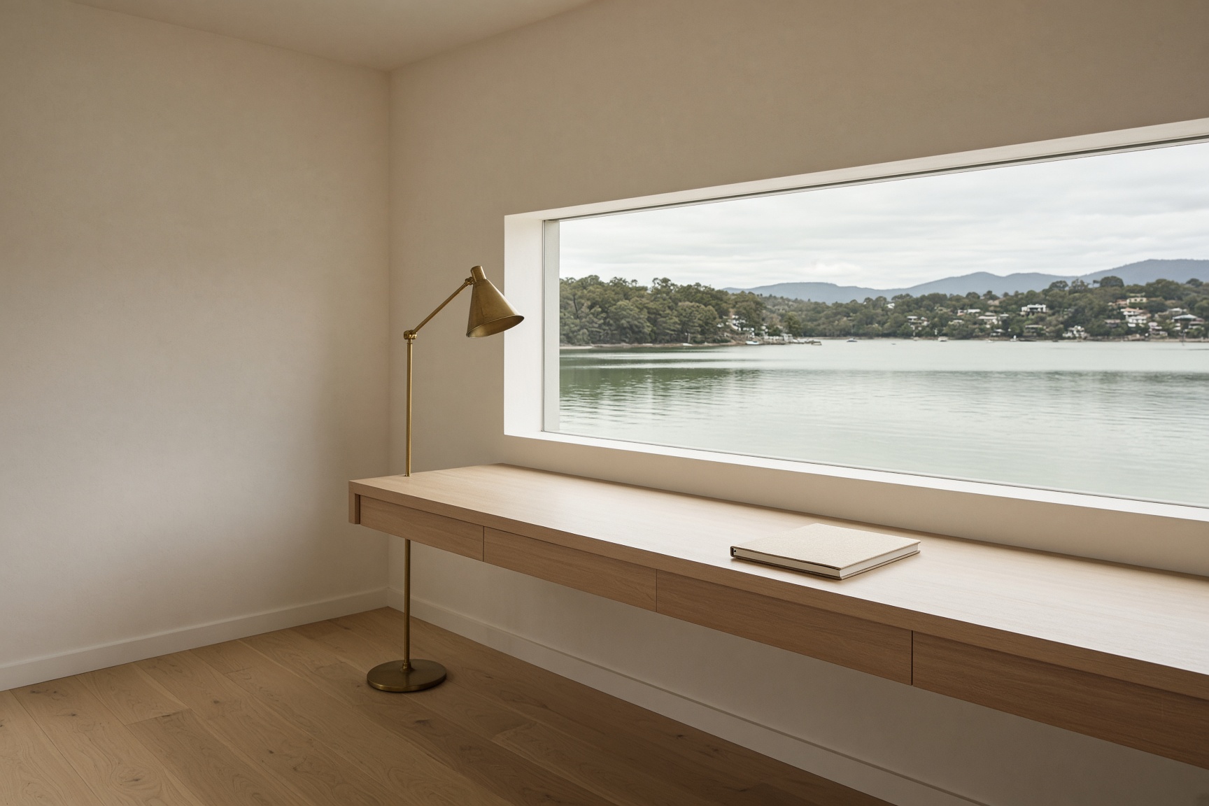 A spare waterfront studio, timber, cream plaster and a window onto the harbour.